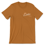 Caramel colored t-shirt with a logo on the heart that says DFTBA don't forget to be awesome. There is an illustrated cowboy hat on the acronym text which also looks like it is a rope.
