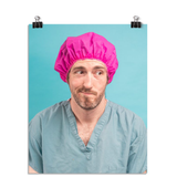 Photo of a man in green scrubs and a hot pink hair net looking to the side like "welp". On a seafoam colored background.