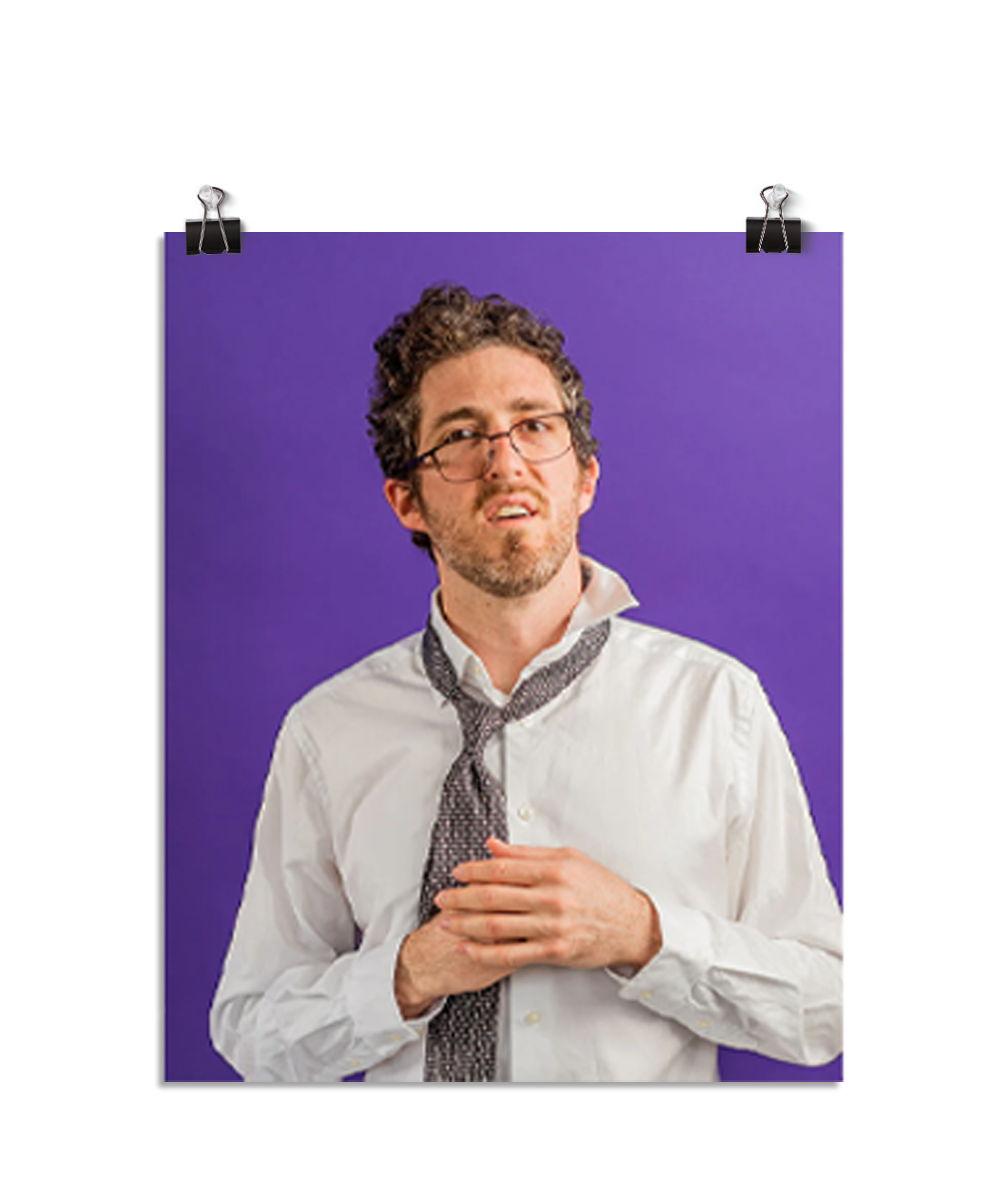 Photo of a man with his glasses askew on his face and ruffled tie and white dress shirt. He looks confused. On a purple background.