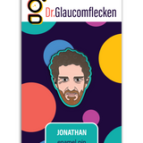 Enamel pin with black metal plating that has the head of a man grimacing staring at you on a teal background. Backing card is purple with colorful dots with the text at the top reading, "Dr. Glaucomflecken" and text on the bottom noting, "JONATHAN enamel pin"