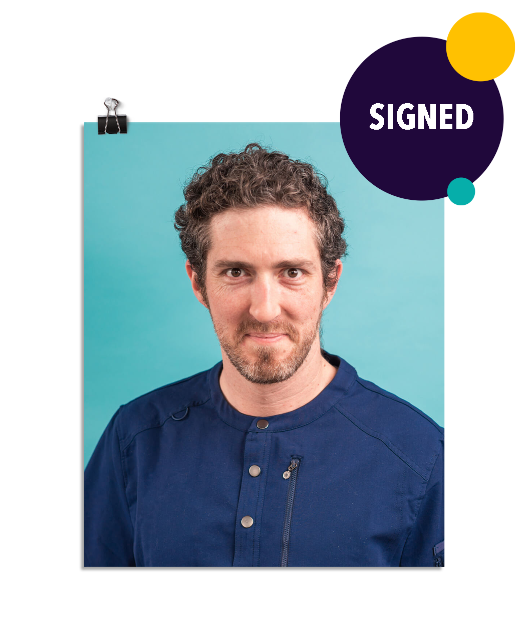 Photo of a man in navy blue scrubs with a soft smile and determined eyes that are a bit haunting. On a seafoam colored background. This print is signed by Jonathan!