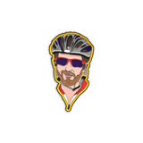 Enamel pin with black metal plating that has the bust of a man with a bike helmet and sunglasses looking at you on a yellow background.