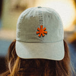 Light denim colored hat with orange asterisk embroidered on the front center.