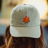 Light denim colored hat with orange asterisk embroidered on the front center.
