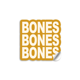 3" vinyl die cut sticker with bold block text. And a  mustard colored sticker with off white text reads, "BONES BONES BONES".