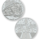 A digital mockup of a silver coin. The front shows an image of a bus with the text "One DBloon; Agimus Liberos Adjutum" The back shows an image of a road and tree-shaped air freshener with the text "Desert Bus for Hope 2021"