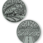 A digital mockup of a dark silver coin. The front shows an image of a bus with the text "One DBloon; Agimus Liberos Adjutum" The back shows an image of a road and tree-shaped air freshener with the text "Desert Bus for Hope 2024"