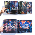 A photo of several inner pages from the Desert Bus for Hope 2023 photo book.