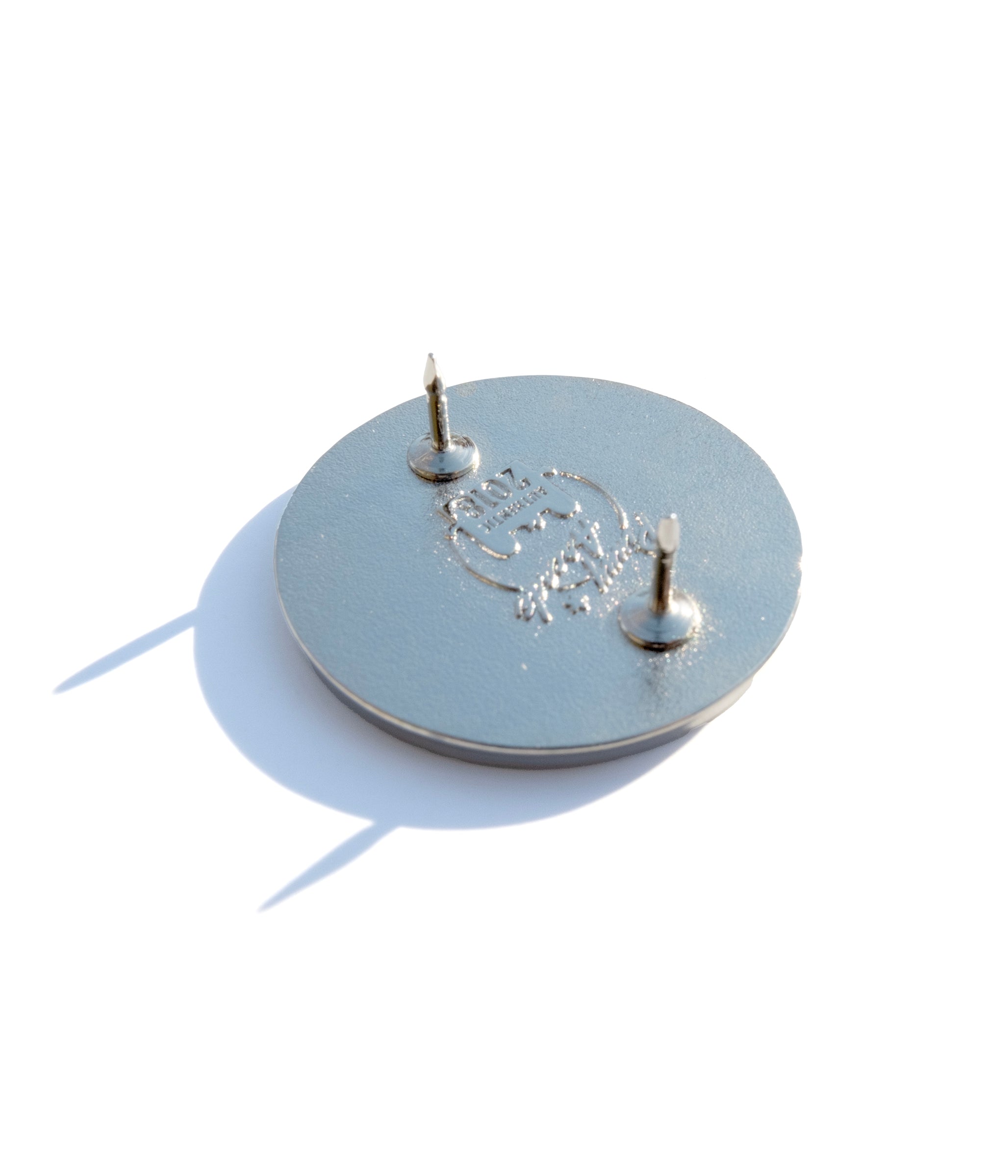 Photo of the back of the pin with a Pinny Arcade backstamp.