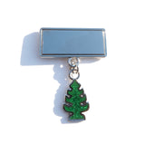 Photo of a pin with a mirrored surface and dangling glittery air freshener shaped charm