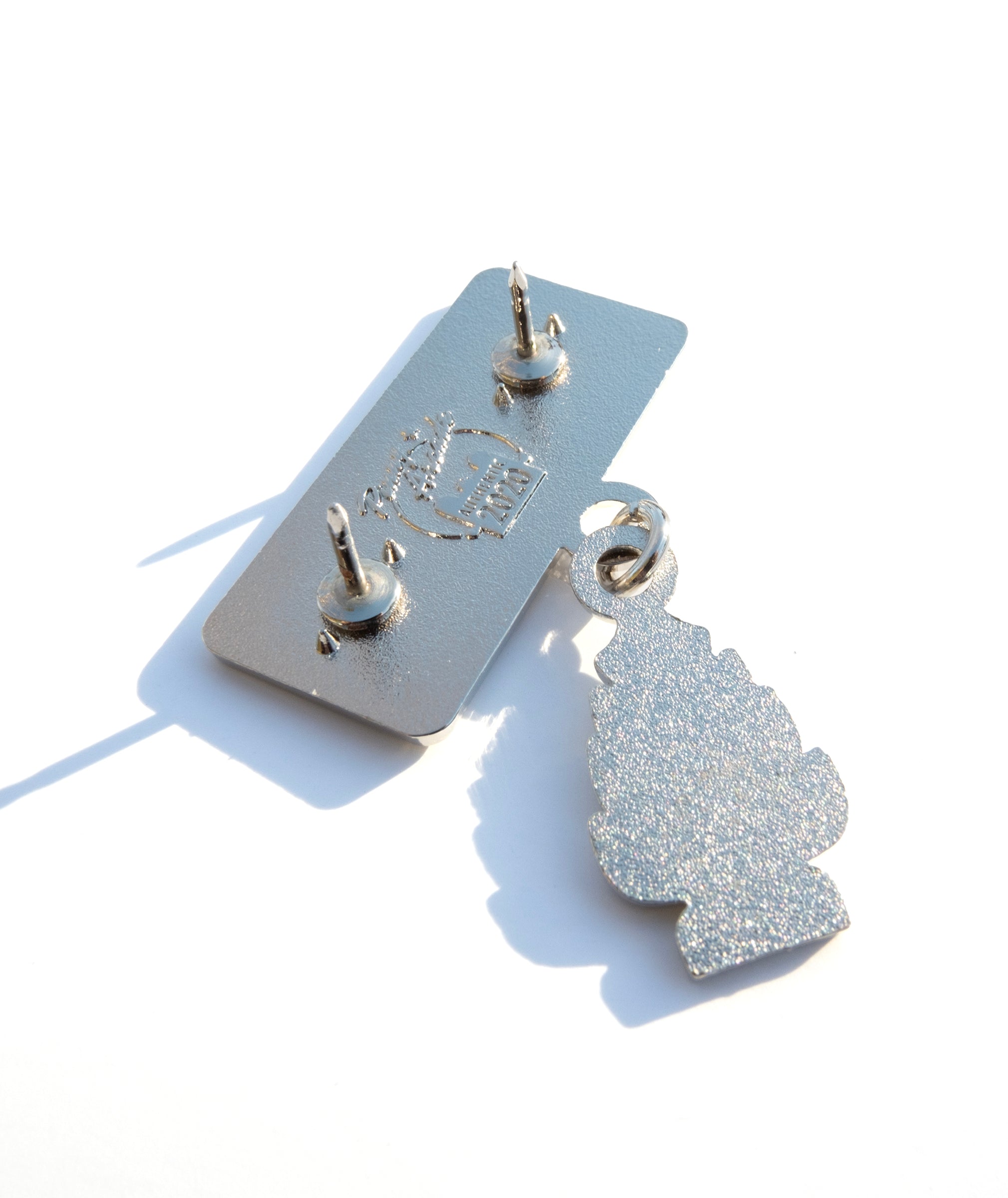 Photo of the back of the pin with a Pinny Arcade backstamp.