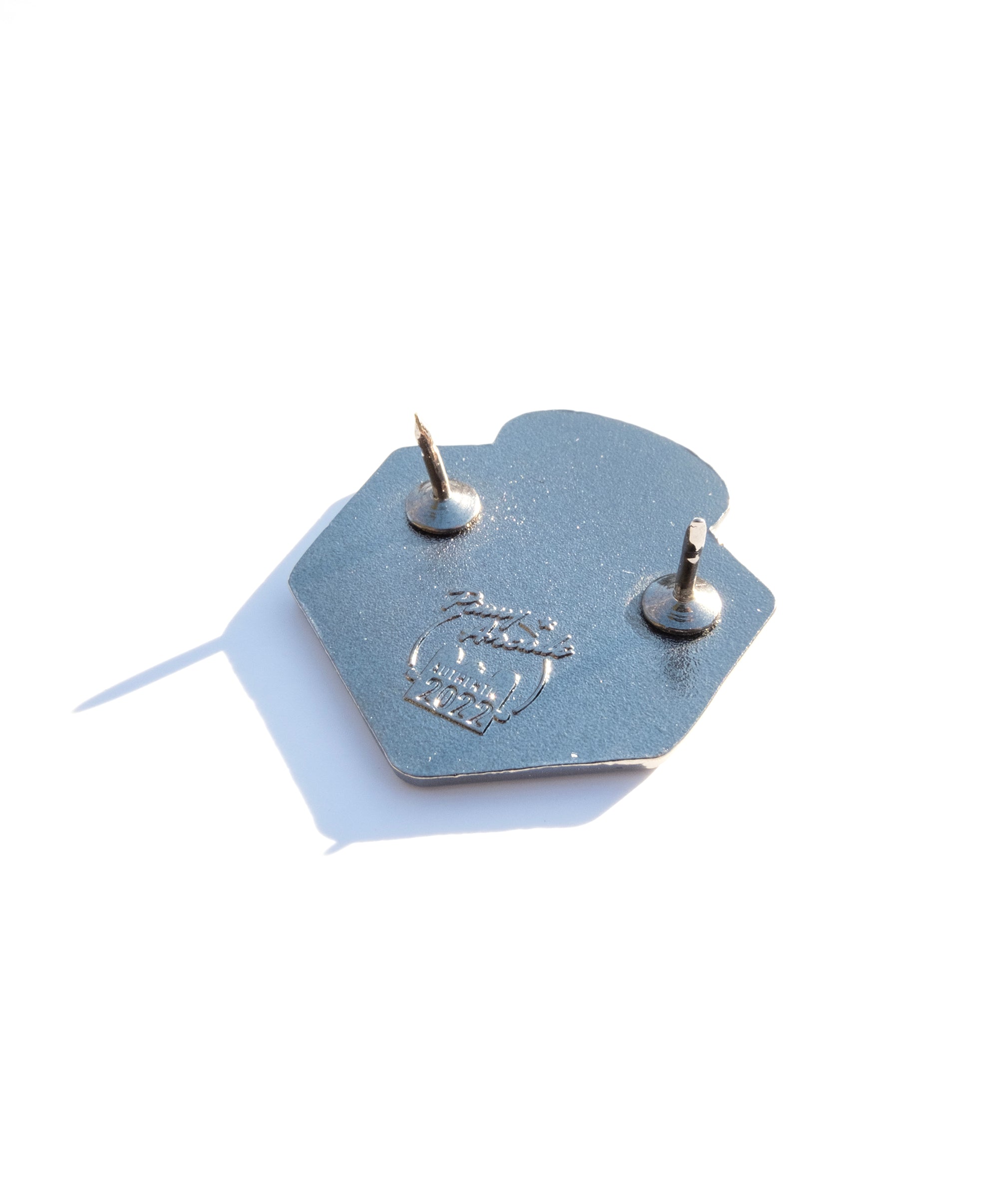 Photo of the back of the pin with a Pinny Arcade backstamp.
