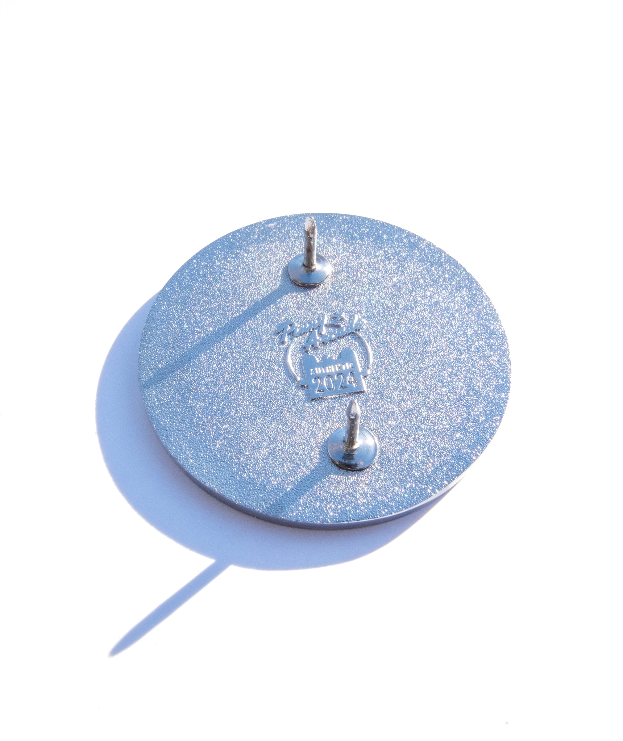 Photo of the back of the pin with a Pinny Arcade backstamp.