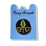 A photo of a pin on a blue Pinny Arcade Pin Trading backer card. It has a black glitter background and neon outlines of a road and tree-shaped air freshener.