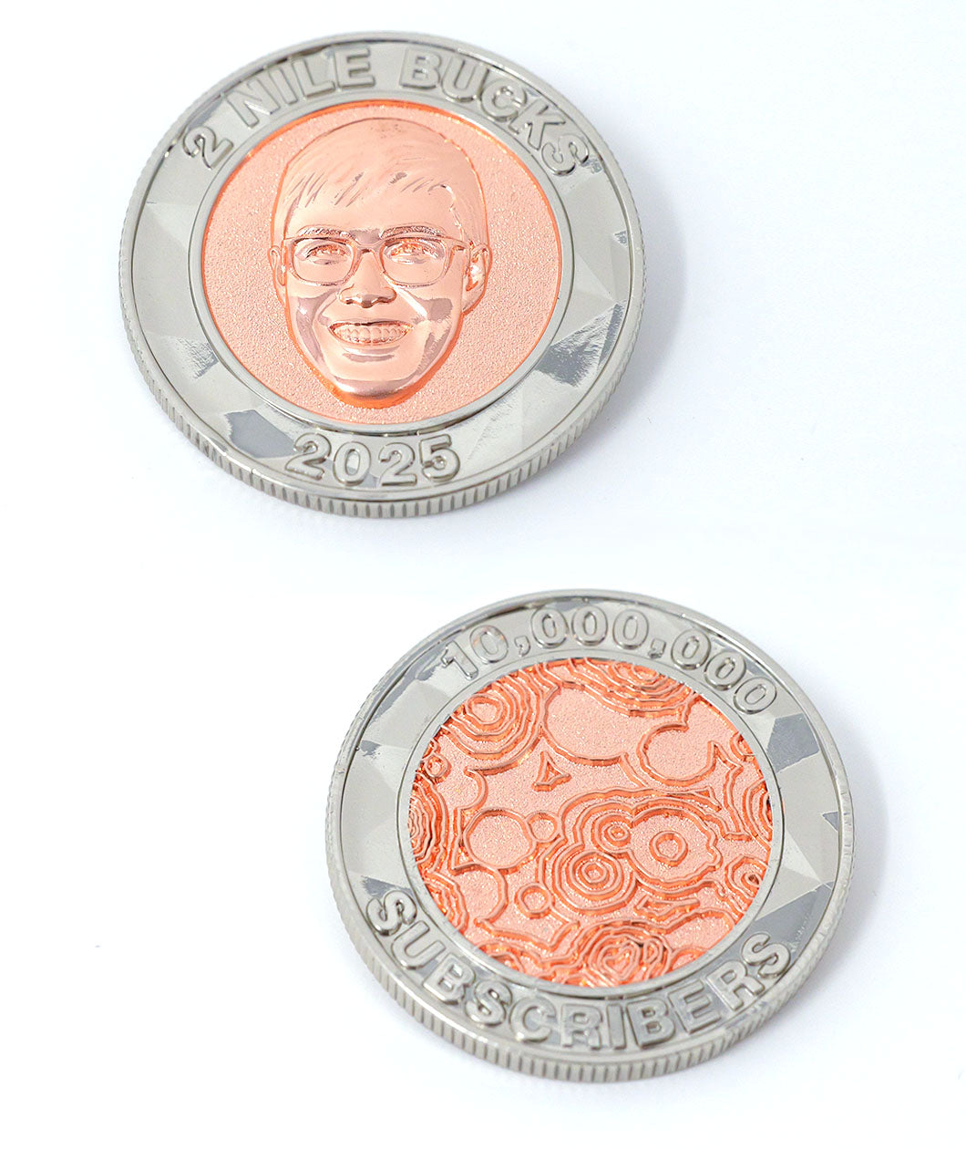 A photo showing two sides of a coin. The first shows an image of Nigel from NileRed and the text "2 Nile Bucks; 2025" and the second shows the NileRed logo and the text "10,000,000 Subscribers" Both sides have a diamond fractal pattern.