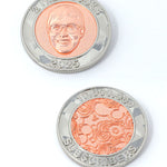 A photo showing two sides of a coin. The first shows an image of Nigel from NileRed and the text "2 Nile Bucks; 2025" and the second shows the NileRed logo and the text "10,000,000 Subscribers" Both sides have a diamond fractal pattern.