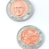 A photo showing two sides of a coin. The first shows an image of Nigel from NileRed and the text "2 Nile Bucks; 2025" and the second shows the NileRed logo and the text "10,000,000 Subscribers" Both sides have a diamond fractal pattern.