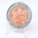 A photo showing a coin on a plastic stand. It has the NileRed logo and the text "10,000,000 Subscribers" with a diamond fractal pattern.