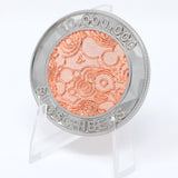 A photo showing a coin on a plastic stand. It has the NileRed logo and the text "10,000,000 Subscribers" with a diamond fractal pattern.