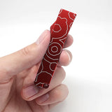 A hand holding a closed bottle opener