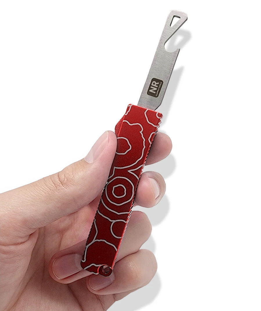 A hand holding an open red bottle opener