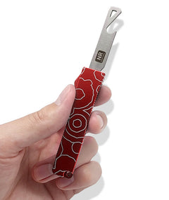 A hand holding an open red bottle opener