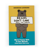 The cover of a book with a yellow and blue background with an an illustration of a bear standing up holding a sign that says "Beats Don't Care About Your Problems". Above the bear reads "Brendan Leonard" and below the bear reads "More Funny Shit in the Woods from Semi-Rad.com.