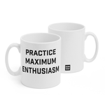 Two white mugs sitting next to each other showing two sides of the same mug. The front side has text that reads "Practice Maximum Enthusiasm" in black, caps lettering. On the back of the mug is a small black square with the words "Semi Rad".