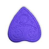 A purple bath bath bomb shaped like an upside down heart with indentations of shapes. From Spirits.