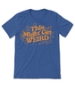  A blue shirt with fun, curvy orange text that reads "This Might Get WEIRD" across the chest. Around the text are illustrated outlines of objects like hot dogs, cats, stars and planets.