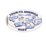 An oval shaped white decal showing different cities around the world with the text "Tour-th America 2023". 