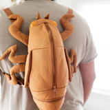 Man wearing cicada shell shaped backpack.