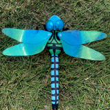 Bright blue dragonfly plush with iridescent wings outstretched attached to a green body with black markings.