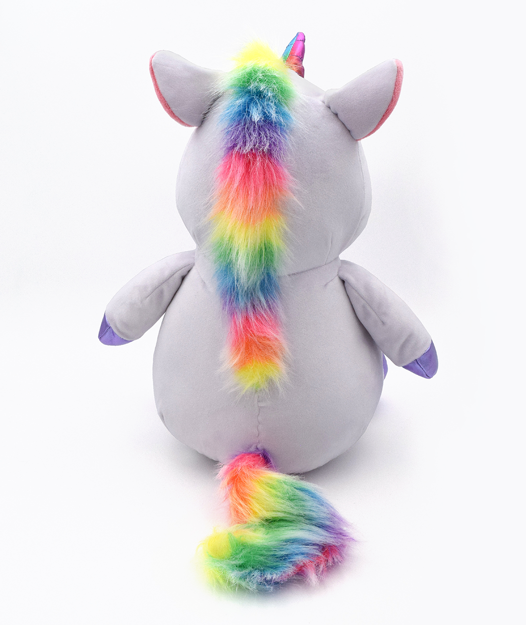 Back of Garyl plushie shows the rainbow fur mane that flows from the top of its head to the middle of its back. Then it has a rainbow fur tail as well.