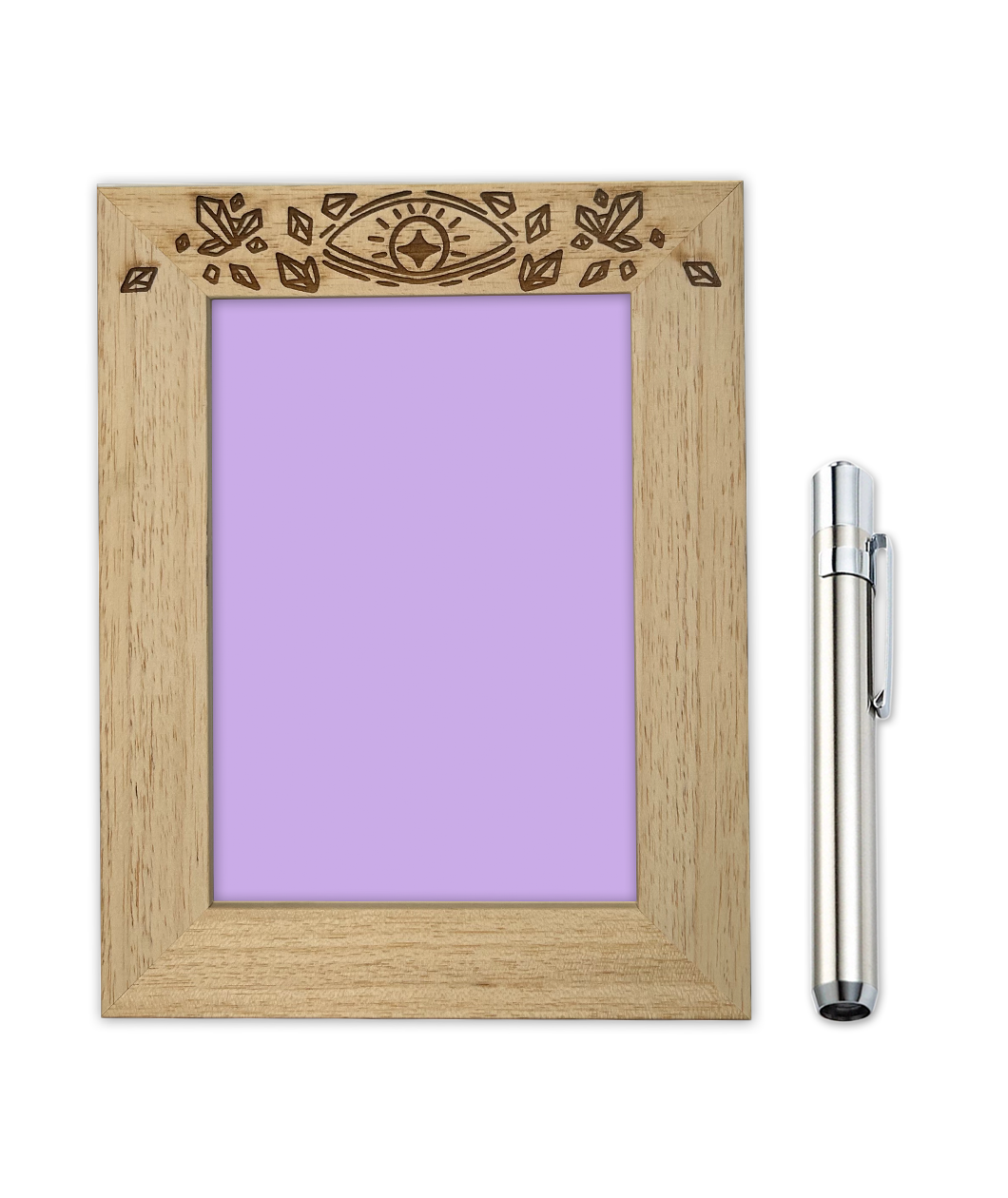 A wooden frame with printed crystals on the top. The middle of the frame has a light purple background. A UV pen sits beside it. From Tyler Thrasher. 