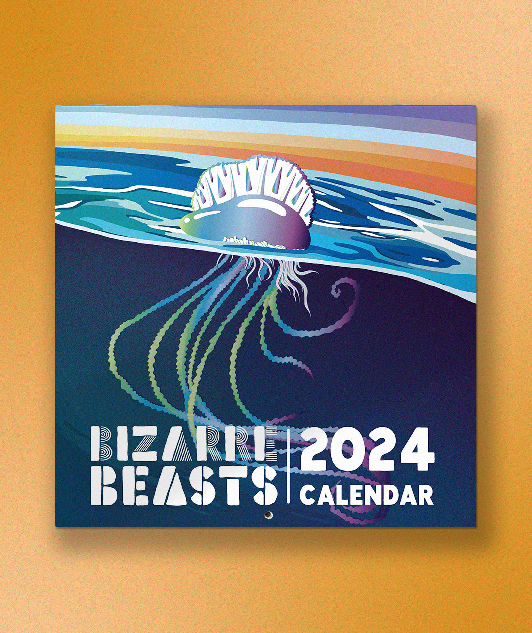 The cover of the Bizarre Beasts 2024 Calendar in front of a yellow background. The cover is a colorful illustration of a jellyfish on the surface of the water.