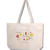 Mockup of natural cotton tote featuring a design of various sewing supplies with the caption "Essentials Only"