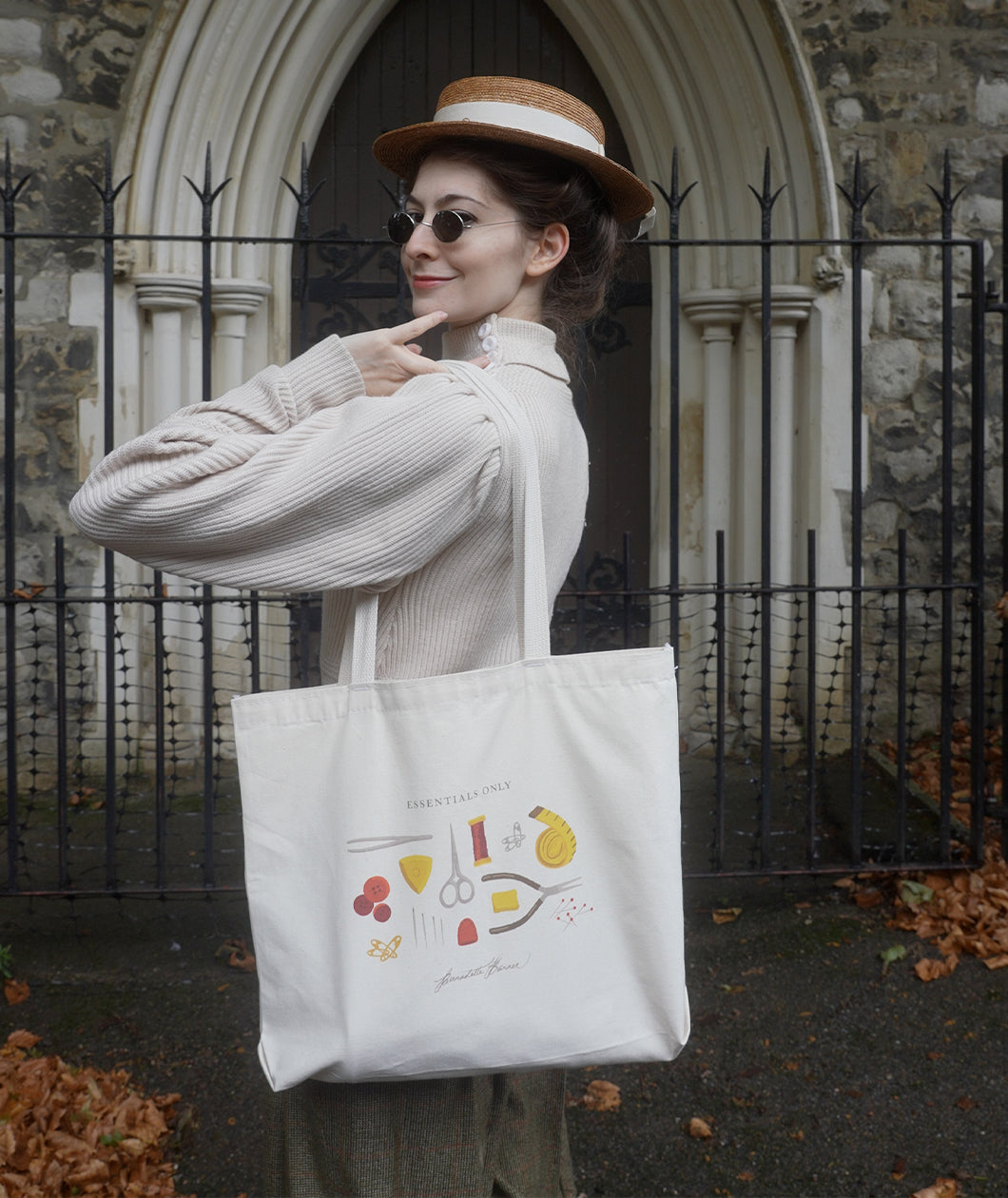 A photograph of Bernadette posing with the Essentials Only Tote Bag