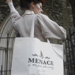 A photograph of Bernadette posing showing the Menace to Polite Society tote bag over her shoulder.