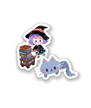 A set of 2 stickers. The first is of a gray cat and the second is of a little witch pushing a stack of books in a wooden cart.