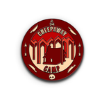 A circular pin with a dark red band goes around the outside with icons of a campfire, knives, arrows and a skull. Inside the circle is a small log cabin and text that reads "Creepaway Camp" all in different shades of red and white. From Creepy.