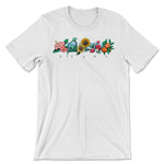 A white t-shirt with a band of colorful, illustrated flowers across the chest with the letters "DFTBA" below. 