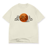 An off-white t-shirt with a printed design on the front. The design is of wavy black text over an illustration of an orange. The text reads, "lorem ipsum dolor sit, lauren epsum solo shit, dougus dippus deltoid dump, crampus krungus forrest gump". From Drawfee.