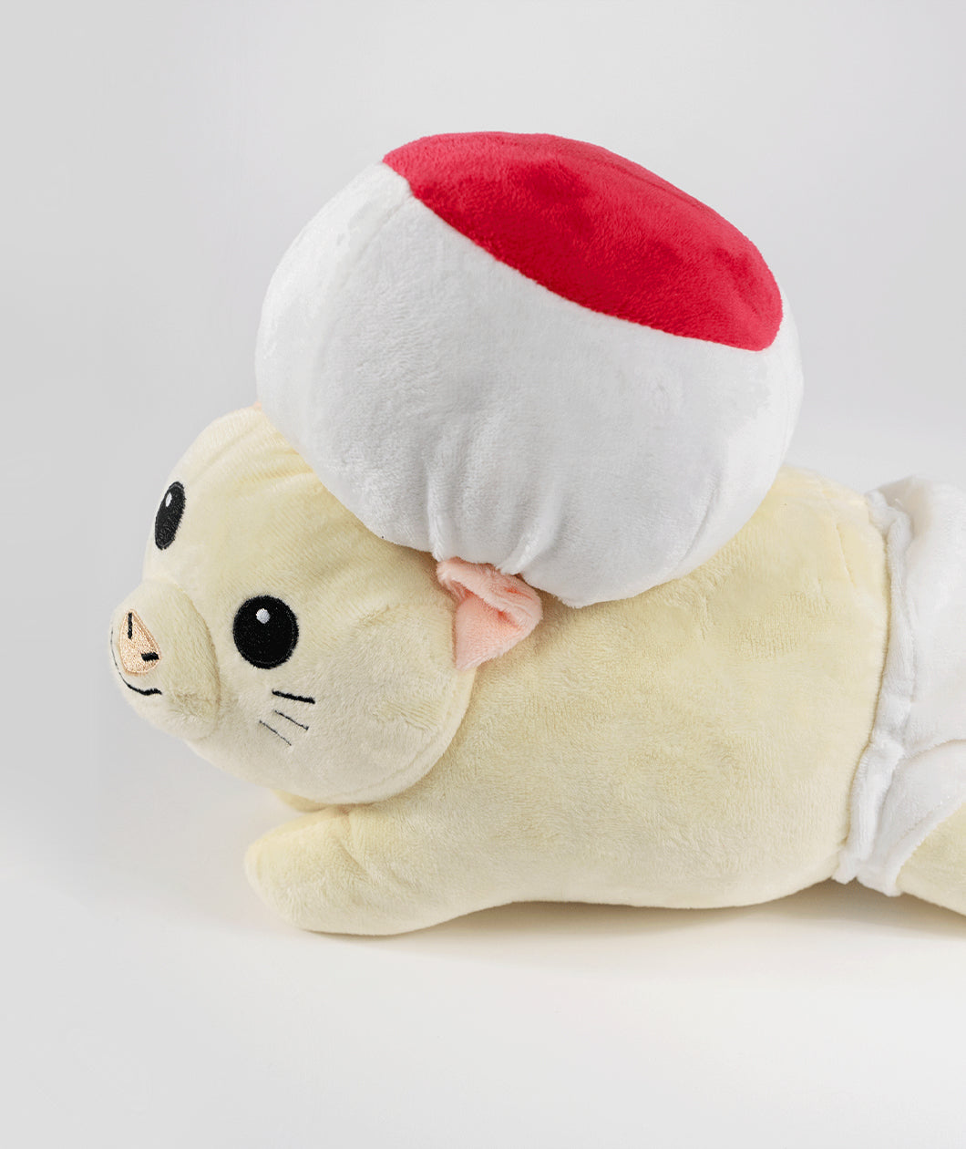 A side view photo of a mouse plushie with a round hat and a white diaper. The plushie is of Drawfee's character Todd. From Drawfee.