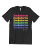 A black t-shirt the "Bookstores" written six times stacked on top of each other, each word in a different color of the rainbow. There is a small Libro.fm logo below the words. 
