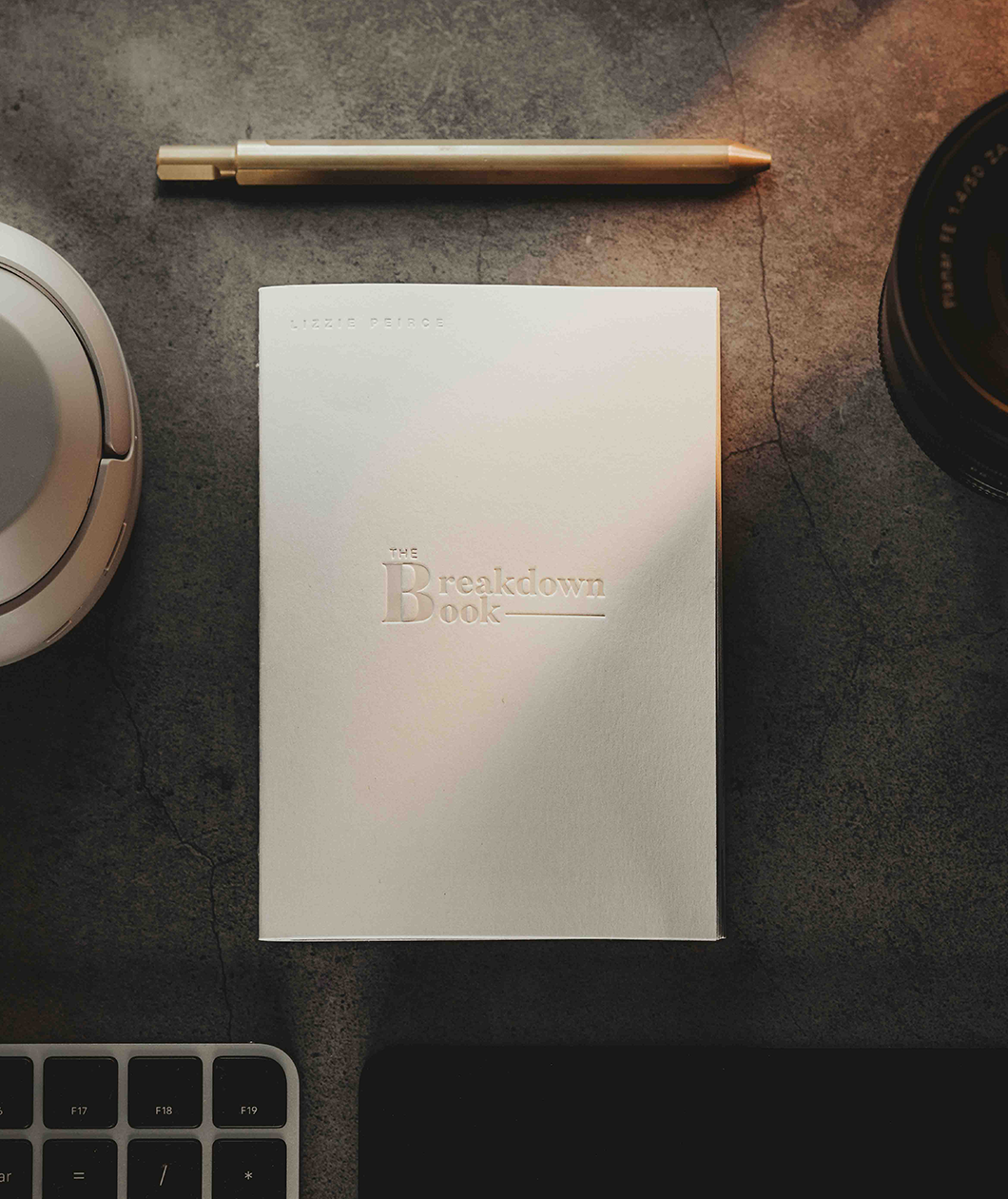 A white notebook with the text "The Breakdown Book" on the front from Lizzie Peirce. 