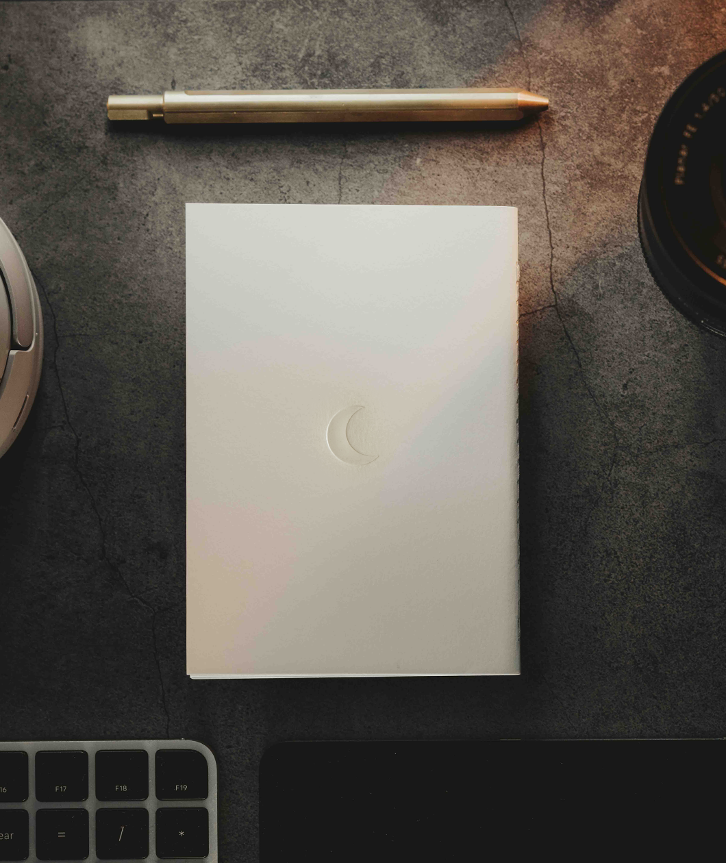 A white notebook with a printed crescent moon on the back from Lizzie Peirce. 