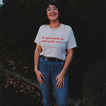 A person wearing an off-white t-shirt with cursive red text across the front that reads "Do you want to read with me?" from Middlecase.