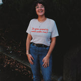 A person wearing an off-white t-shirt with cursive red text across the front that reads "Do you want to read with me?" from Middlecase.