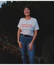 A person wearing an off-white t-shirt with cursive red text across the front that reads "Do you want to read with me?" from Middlecase.